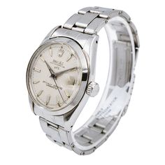 Men's Rolex 34mm Date Vintage Stainless Steel Watch with Cream Dial and Smooth Bezel. Pre-Owned SN# 485**** Year: 1976. Brand: Rolex. Crystal: Plastic. Gender: Men's. Case Back: Solid. Dial Color: Silver Dial. Condition: Very Good. Model Number: 6534. Case Dimensions: 34mm. Metal Type: Stainless Steel. Bezel Color: Stainless Steel. Model: Oyster Perpetual Date. Bracelet / Strap: Stainless Steel. Movement: Mechanical (Automatic). Box / Certificate: Rolex Box / Certificate of Authenticity. Service Warranty: One (1) Year Limited Service Warranty. Classic Automatic Watch For Anniversary, Classic Watch With Polished Finish For Anniversary, Classic Watches With Polished Finish For Anniversary, Classic Silver Automatic Watch, Classic Round Dial Jewelry And Watches For Anniversary, Anniversary White Gold Watch Band, Classic Chronometer Watch With Round Dial, Classic Watch Accessories With Chronometer For Anniversary, Classic Automatic Watch Accessories For Anniversary