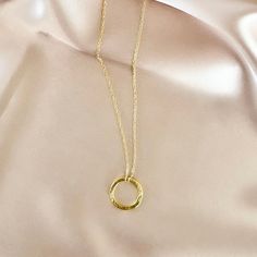 Our signature gold circle necklace is designed for layering over any necklace in our collection. Handmade, tarnish resistant 14k gold plated chain. Adjustable between 16"-18". Gold-tone 14k Gold Filled Necklaces, Circle Shaped Yellow Gold Necklace With Adjustable Chain, Gold-tone 14k Gold Filled Necklace, Gold-tone Round 14k Gold Filled Necklace, Gold Circular Charm Necklace With Adjustable Chain, Dainty Gold Chain Round Charm Necklace, Minimalist Gold Open Circle Necklace, Gold-tone Charm Necklace With Delicate Chain, Gold Minimalist Open Circle Necklace