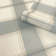 a close up view of a plaid pattern on a bed sheet that is not made