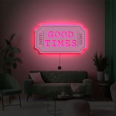 a neon sign that says good times on the wall next to a couch and chair