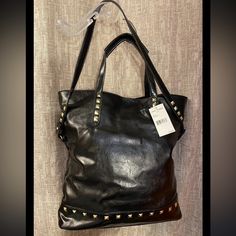 Steve Madden Black Gold Studded Handbag Tote Faux Leather Shoulder Bag. Great Bag To Carry Picnic Items Or Go To The Beach - Fancy Gym Bag Or Travel Luggage. The Interior Of The Bag Is 100% Cotton With A Black And White Herringbone Print. The Tote Measures 17” High, 17” Deep, 5” Wide, 8” Shoulder Drop And Has Carry Handles Also. Brand New With Tags! Fast Shipping! Edgy Rectangular Bags For Everyday Use, Edgy Black Leather Satchel, Everyday Faux Leather Shoulder Bag With Gunmetal Hardware, Fall Shoulder Bag With Gold-tone Hardware For Errands, Trendy Hobo Tote Bag With Snap Closure, Trendy Hobo Bag Tote With Snap Closure, Edgy Leather Rectangular Shoulder Bag, Shoulder Bag With Snap Closure For Shopping, Edgy Rectangular Leather Shoulder Bag