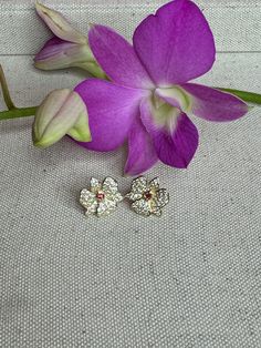 🌸 Orchidique's Limited Edition Dendrobium Orchid Earrings: 🌸 Key Features: Size: 15mm - Perfect for everyday elegance. Material: Luxurious S925 sterling silver - Durable and hypoallergenic. Radiant 14K gold plating - Adds warmth and a touch of opulence. Genuine white and red zircon - Captures the timeless beauty of a blooming dendrobium orchid. Design: Unique, one-of-a-kind floral dendrobium orchid pattern - Inspired by our family's first blooming Dendrobium orchid 30 years ago and lovingly ha Anniversary Flower Shaped Clip-on Earrings, Elegant Orchid Flower Earrings, Flower Shaped Clip-on Earrings For Anniversary, Anniversary Flower Clip-on Earrings, Anniversary Clip-on Flower Earrings, Orchid Flower-shaped Earrings For Gift, Flower Shaped Clip-on Earrings For Gift, Clip-on Flower Earrings Gift, Yellow Gold Flower Clip-on Earrings As Gift