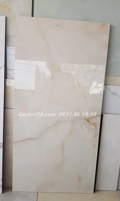 several white marble tiles stacked on top of each other in different sizes and colors,