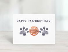 a card that says happy pawher's day with an image of a tennis ball and paws