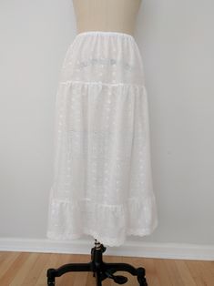 "An exquisite accessory for your wardrobe, this feminine underskirt worn with your skirt or dress will make you feel very special ! This skirt is made of a nice 100% white cotton scalloped eyelet fabric with elastic waistband. This white ruffly underskirt is perfect for so many beautiful outfits. This accessory makes a perfect gift! * Sizing* This skirt can be made to your length and waist specifications. The skirt length shown is 30\". However it can be made slightly longer or much shorter. Eas Feminine White Skirt With Ruffle Hem, Feminine White Ruffled Maxi Skirt, Feminine White Maxi Skirt With Ruffles, Elegant Tiered Relaxed Skirt, Summer Wedding Ruffled Maxi Skirt, White Feminine Tiered Maxi Skirt, Feminine White Maxi Skirt For Beach, Summer Wedding Skirt With Ruffles, Elegant Tiered Summer Skirt