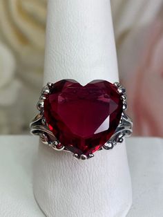 Red Heart Gem Sterling Silver RingHeart Leaf Design#D213 This Gothic inspired lovely filigree ring is set with a 10ct flawless red gemstone. This heart gemstone is 15mm x 15mm. The rings sits 11mm off the finger. Notice the beautiful gothic design of the silver filigree setting and band. The inside of the band is marked 925 for sterling silver. This is an exquisite rendition of an antique filigree ring. The sterling filigree cradles the stone in a delicate caress. Classic and beautiful, this vin Garnet Heart Ring, Vampire Rings, Vampire Ring, Gothic Wedding Rings, Heart Gem, Garnet Heart, Gothic Ring, Gem Art, Antique Jewelry Rings