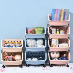 several plastic storage containers stacked on top of each other in front of a blue wall