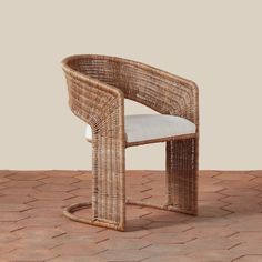 a wicker chair sitting on top of a brick floor