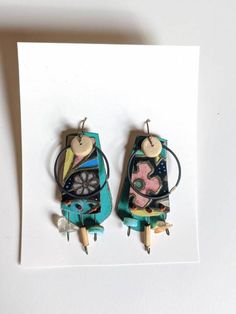 I love vintage floral tins, this pair combines a fun floral piece with a fabulous turquoise green base, and fun bits of bamboo, shell and stone. Handmade Eclectic Green Jewelry, Whimsical Green Hand Painted Earrings, Green Hand-painted Bohemian Earrings, Green Hand Painted Bohemian Earrings, Handmade Artistic Green Earrings, Green Bohemian Hand Painted Jewelry, Green Bohemian Patina Earrings, Green Bohemian Earrings With Patina, Green Patina Bohemian Earrings