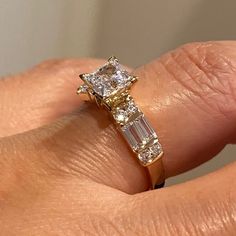 a woman's hand with a yellow and white diamond ring