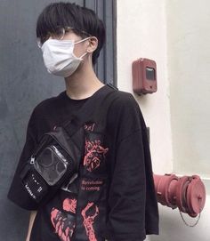 a person wearing a face mask and holding a camera