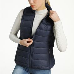 Jodie Womens Puffer Vest By Alpine Swiss Product Features: 100% Nylon Shell, 100% Polyester Fill & Lining STYLISH – The Jodie womens puffer vest is stylish and versatile. Wear it over T-shirts, long sleeve shirts, button downs, or sweaters for endless combinations of warm and fashionable ensembles. WARM – A down alternative filling makes this vest ultra-lightweight and comfortably warm while allowing your arms to have full range of motion. WATER RESISTANT – The nylon shell construction is durabl Cold Weather Solid Puffer Vest, Outdoor Puffer Vest Jacket Sleeveless, Cheap Moisture-wicking Athleisure Vest, Cotton Vest For Cold Weather/winter, Navy Puffer Vest, Bubble Vest, Dickies Women, Womens Puffer Vest, Casual Tees