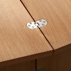 a close up view of a wooden cabinet door with two metal latches on it