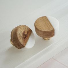 two wooden knobs on top of a white surface