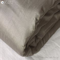 Exclusive Steel Grey Pure Dupioni Silk Fabric Indian Raw Silk Fabric by the yard Dupion  Cushions Table Covers Crafting Costumes Dresses Pillows ➤Color: Steel Grey ➤Quality: The fabric is 100% dupioni silk of the highest grade. (100gsm) ➤Width: 44 inches ➤Code: sf272 ➤Listing for 1 Yard of fabric   Steel Grey dupioni silk or raw silk fabric, made from pure silk yarn. This is a very beautiful tone-on-tone Steel Grey Color. Indian dupioni silk or raw silk fabric, made from pure silk yarn. 100% pure silk fabric has been made in India by skilled loom weavers.  This dupioni is perfect for bridal & bridesmaids dresses, drapery, quilting, pillows, & chair upholstery, Dresses, Tops, Blouses, Jackets, Crafting, Clutches or Evening Bags, Embellish your clothes, Home Décor, Outdoor, Quilting, Sewing, Table Cover Diy, Dupioni Silk Fabric, Costumes Dresses, Raw Silk Fabric, Women Costumes, Dupioni Silk, Bridal Bridesmaid Dresses, Table Diy, Dupion Silk