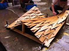 a man is working on a wooden structure