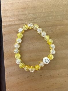 This is a larger sized bracelet, but can be made smaller for kids if needed. Glass beads are yellow and clear with a smiley bead included! Stretchy band. Yellow Beaded Bracelets With Round Beads For Everyday, Yellow Round Bead Bracelets For Everyday, Yellow Round Beads Bracelet For Everyday, Yellow Beaded Bracelets For Everyday, Trendy Adjustable Clear Bracelets, Fun White Plastic Jewelry, Fun Yellow Round Beads Jewelry, Fun Yellow Round Beaded Jewelry, Casual Round Yellow Jewelry