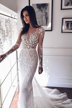 a woman in a white wedding dress is posing for the camera with her hand on her hip