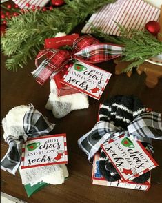 christmas stockings are wrapped in red and black plaid ribbon, with holiday tags attached to them