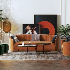 a living room with orange couches and art on the wall behind them in an apartment