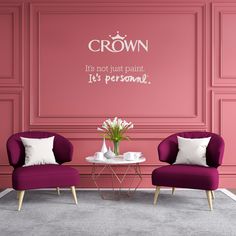 two purple chairs in front of a pink wall with the words crown written on it