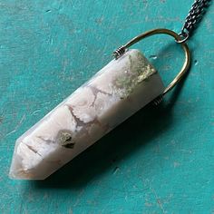 I recently sourced some beautiful crystals and stones so that we could make some more unique Taliswoman necklaces!This listing is for a lovely Cherry Blossom Agate, measuring 2 1/8" tall and 3/4" wide at the top of the stone, suspended from a brass bail with a 20" Sterling Silver chain. Cherry Blossom Agate is the stone of dreamers! If you are a person who is goal driven and has high hopes from life, then a Cherry Blossom Agate will keep you striving after them constantly! The rock is known to n Unique Crystal Necklaces With Large Stone For Healing, Bohemian White Jewelry With Natural Inclusions, Unique Agate Gemstone Crystal Necklaces, Agate Necklaces With Natural Inclusions For Healing, Unique Agate Gemstone Crystal Necklace, Unique Quartz Crystal Necklaces With Natural Stones, Bohemian Pendant Crystal Necklaces With Large Stone, Large Stone Pendant Crystal Necklace, Unique Quartz Crystal Necklace With Gemstone