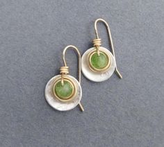 Faceted green genuine peridot gemstones, weighing 1.25 carats each, are wrapped in gold filled wire, then set within a sterling disc dangle. Ear hooks are handcrafted in gold filled wire. Artisan elegance and lightweight design make these earrings perfect for all day wear and comfort. Also are a great gift for a special someone with an August birthday, as peridot is August's birthstone. Genuine peridot, 1.25 carats each (2.5 carats per pair), pale green with natural inclusions visible. Earring D 16th Anniversary Gifts, 19th Anniversary Gifts, 16th Anniversary, August Birthday, Peridot Earrings, Anniversary Gift For Wife, August Birthstone, Birthstone Gifts, Anniversary Gifts For Wife