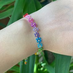 Rainbow coloured bead bracelet with a delicate design. The Floral Daisy Bracelet will brighten up your look. A beaded bracelet crafted by hand with high-quality beads. Galvanized gold beads and shiny beads are used to embellish it. Thank you very much for visiting our shop. We hope you have a great shopping experience! If you are struggling to find the information you need, please feel free to contact us. Do not forget to take a look at our other products in our shop. 😊 ➡️ Matching necklace: ⬇️ Colorful Flower-shaped Bracelets For Gifts, Colorful Flower Bracelets For Gifts, Colorful Flower Bracelets As Gift, Multicolor Flower Friendship Bracelets As Gift, Rainbow Tiny Beads Bracelet, Adjustable Flower Friendship Bracelets With Colorful Beads, Adjustable Flower-shaped Friendship Bracelets With Colorful Beads, Multicolor Flower Friendship Bracelets, Adjustable Multicolor Flower Beaded Bracelets