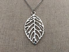 "Perfect for everyday wear, here is a beautiful and highly detailed silver leaf pendant necklace. It is timeless and sophisticated. Made from allergy free plated silver and hangs from a shiny and strong 18\" stainless steel necklace chain with a little lobster clasp. Leaf Pendant measures 1 7/8\" long by 1\" wide. I have matching earrings in my shop if you would like the whole set. https://www.etsy.com/listing/163035745/big-silver-leaf-earrings-statement Thanks for stopping by! Please take a mom Silver Leaf-shaped Nature-inspired Necklace, Silver Leaf-shaped Necklaces For Gift, Silver Leaf-shaped Necklace Gift, Silver Leaf-shaped Necklace For Gift, Handmade Silver Leaf-shaped Necklace, Silver Leaf-shaped Sterling Silver Necklace, Silver Leaf-shaped Necklace, Silver Leaf Jewelry For Jewelry Making, Silver Leaf-shaped Jewelry For Jewelry Making