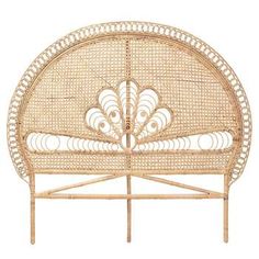 a wicker headboard with an intricate design on the top and bottom, made out of rattan