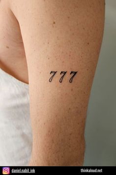 the back of a woman's arm with numbers tattooed on her left side, which reads 477