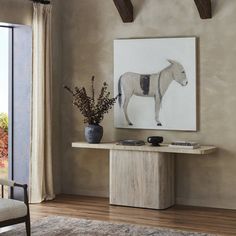 a room with a horse painting on the wall