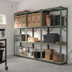 a room filled with lots of boxes and containers on top of shelves next to a bike