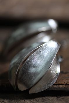 The inspiration for these elegant silver stud earrings come from the shape of the fragrant cananga flower, commonly called Ylang-ylang in English. They are entirely handmade from 95% silver and are very lightweight and comfortable to wear. The surface was etched with the so-called cat-fur technique, typically used by Thai Karen silversmiths. Our products are hand crafted in 95-98% Silver by Thai Karen hill-tribe artisans. The Karen are a group of ethnic peoples who reside primarily in southern a Flower Handmade, Silver Earrings Handmade, Silver Stud Earrings, Silver Earring, Ylang Ylang, Silver Earrings Studs, Silver Studs, Wearable Art, Handmade Silver