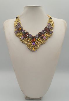 Each piece of our statement necklaces is handmade and one of a kind made in Italy. Our creations is made of high quality materials such as crystals and rhinestones. Each embroidered material is carefully hand sewn. Very glamorous and stylish. Perfect gift to someone you like. Materials Strass stone and Rhinestone in Rainbow, Cooper and Brown color in different dimension.  Black satin fabric backing. Aluminium chain with lobster closure. Measurements Weight approximate 200 grams. Chain lenght 25 cm - 9.84 in Circumference approximate 63 cm - 24.80 in Feel free to contact us if you have any question. Thank you so much for looking at our shop and our articles each of them, single piece. Luxury Gold Beaded Necklace For Party, Costume Jewelry Jeweled Choker Necklace, Luxury Jeweled Choker Necklace, Costume Jewelry Rhinestone Pendant Necklace For Party, Costume Jewelry Necklace With Sparkling Stones For Party, Luxury Jeweled Bridal Necklace Gift, Handmade Choker Necklace For Evening, Elegant Multicolor Evening Necklaces, Bridal Pendant Necklace With 17 Jewels For Party