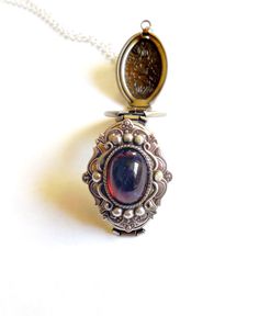 Dragon's breath is sometimes called Mexican glass fire opal, it's a handmade stone that is a hot redcolor with bright blue reflections. Stunning. Locket size :35 mm x 20 mm that opens to hold 4 photos The dragon breath stone is 14x10 mm across, with a silver frame setting surrounding the jewel. You can put a photo, smudge solid perfume or lip balm in the locket, or just wear empty :) The opal is a deep fuschia red with blue fleck. The antique silver plated floral engraved locket is 35x20mm. The Locket Picture, Dragons Breath Fire Opal, Deep Fuschia, Dragon Breath, Silver Locket Necklace, Engraved Locket, Picture Locket, Antique Locket, Dragons Breath