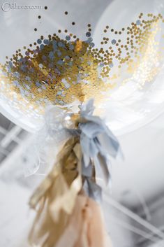 gold and silver confetti in a clear glass vase
