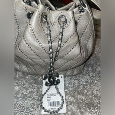 Never Used Tag Still Attached Designer Shoulder Bucket Bag, Designer Pouch Shoulder Bag, Luxury Pouch Bags As Fashion Accessory, High-end Shopping Bags With Silver-tone Hardware, Designer Bucket Bag With Branded Hardware, Designer Satchel Bucket Bag With Branded Hardware, Designer Crossbody Bucket Bag For Shopping, Designer Satchel Bucket Bag, Luxury Silver Bag With Chain Strap