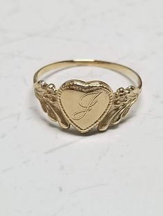 "Thanks for shopping our vintage estate store. We tend to sell well below wholesale and truly hope you enjoy all of our items. Many of the items are one of a kind, so please enjoy scrolling through the pictures and hopefully something will catch your eye. Brown spots are from camera or reflections. Estate 14k yellow gold monogram cursive capital J heart ring. Custom made ring for our shop. Ring size: 3 Setting: 7.5mm 1/4\" to 3/8\" Band width: 1.4mm Weight: .97 gram Marked 14k and it's sweet. On Vintage Gold Initial Ring Stamped 14k, Victorian 14k Gold Jewelry For Valentine's Day, Classic 14k Gold Heart Engraved Ring, Heirloom Engraved Heart Ring, Antique 14k Gold Initial Ring, Classic Heart-shaped Engraved Ring Stamped 14k, Vintage Yellow Gold Jewelry With Engraving Option, Antique 14k Gold Initial Ring As Gift, Vintage 14k Stamped Initial Ring As Gift