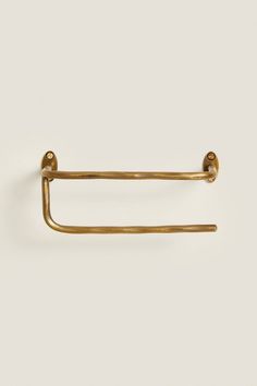 an antique brass towel ring on a white background