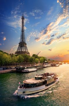 the eiffel tower towering over the city of paris at sunset - stock photo - images