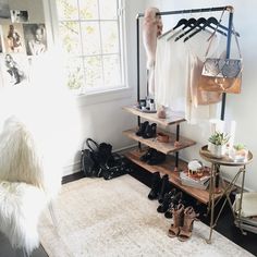 a room filled with shoes and bags next to a window