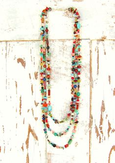 "Three pretty graduated strands of multi color, semi precious stones make up this long bold necklace. Just about every stone you can imagine, turquoise, garnet, lapis, pearls, chrysoprase, red coral, and carnelian, just to name a few. The stones are accented with Bali sterling silver fancy spacers. The necklace measures 33\" in total length. The longest strand measures 33\" the middle strand measures 30\" and the shortest strand measures 27\". All three strands are connected with a sterling silv Silver Heart Jewelry, Semi Precious Stone Bracelet, Art Glass Jewelry, Multi Coloured Necklaces, Necklace Colorful, Blue Beaded Necklace, Silver Heart Earrings, Bold Necklace, Bee Jewelry