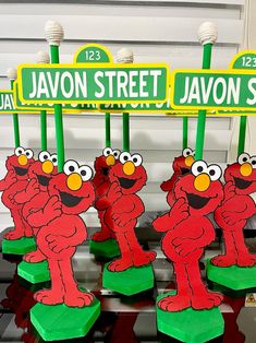 the sesame street signs are made to look like cartoon characters