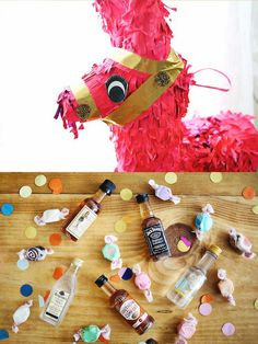 a table topped with bottles and confetti next to a stuffed animal wearing a party hat