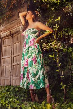 This stunning midi dress boasts a bold and colorful floral print, perfect for making a statement. The strapless design and bare shoulders add an alluring touch, making it a must-have for any sophisticated and stylish wardrobe. Materials: 100% Cotton Sizes: XS, S, M, L Colors: Green/Pink Multi P06 Made in USA Dry clean only Model size: S Style: BNB1906P06 Black Dress Jacket, Stylish Wardrobe, Maxi Dress Sale, Bare Shoulders, Colors Green, New Arrival Dress, Short Rompers, Mini Black Dress, Sweater Jacket