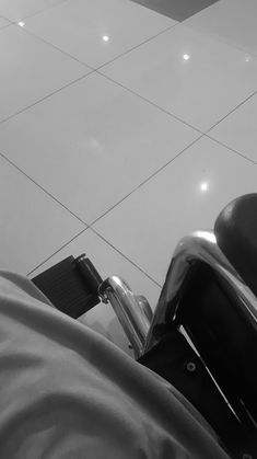 a black and white photo of a person's foot on a scooter