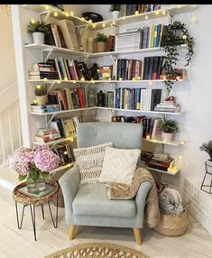 a living room filled with furniture and lots of books