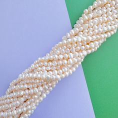 Creamy white "potato" pearls. Naturally unique in shape and texture. Measurements: Each pearl is approximately 8-9x6-7mm. Each strand approximately 16" with approximately 55 beads. White Pearl Rondelle Necklace With Gemstone Beads, White Pearl Necklace With Rondelle Gemstone Beads, Pearl White Oval Beads Pearl Necklace, White Akoya Pearl Necklace In Pear Shape, White Akoya Pearl Necklace, White Oval Pearl Necklace, Cream-colored Round Pearl Bracelet, White Oval Beads Single Strand Pearl Necklace, White Single Strand Pearl Necklace With Oval Beads