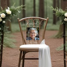 an old lady sitting in a chair next to two wooden chairs with flowers on them